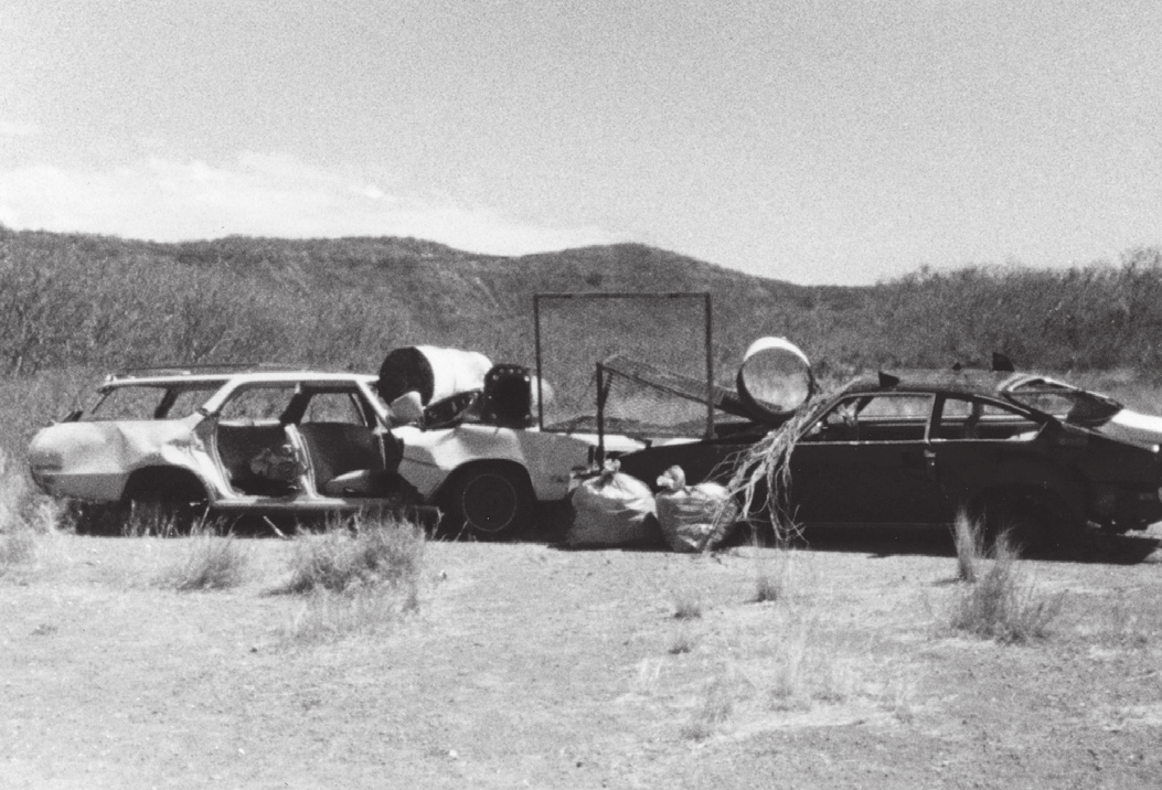 Abandoned car bodies and scrap metal heaped on the crater floor of Diamond Head